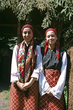 BULGARIA, Pirin Mountain, Chalin Valog, Two girls dressed in Bulgarian national costume.