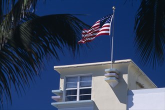 USA, Florida, Miami, South Beach. Ocean Drive. Detail of an Art Deco building with an American flag