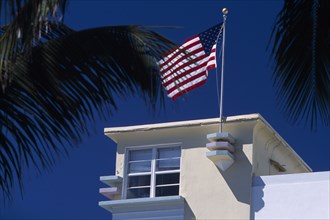 USA, Florida, Miami, South Beach. Ocean Drive. Detail of an Art Deco building with an American flag