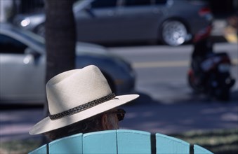 USA, Florida, Miami, South Beach. Ocean Drive. The head of a man wearing a Panama hat seen above