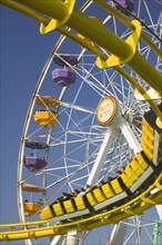 USA, California, Santa Monica, The roller coaster and Pacific Wheel on Santa Monica Pier.