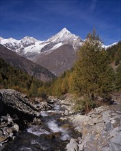 SWITZERLAND, Valais, Weisshorn Mountain, River Taschbach with the Snow capped Weisshorn  Mountain