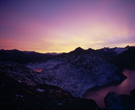 SWITZERLAND, Valais, Grimsel Pass, Sunset over Grimsel Pass. Oberaasee on the left and Grimselsee