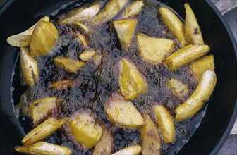 NIGERIA, Food, Cassava and plantain frying in oil.