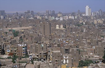 EGYPT, Cairo Area, Cairo, Elevated view over city rooftops with tall buildings on the skyline