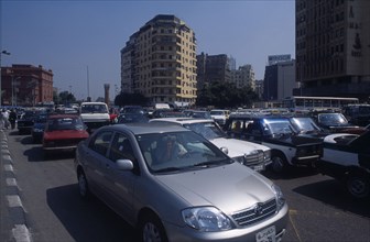 EGYPT, Cairo Area, Cairo, Busy road with traffic and tall buildings behind