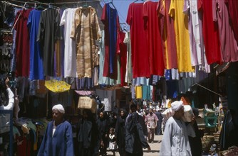 EGYPT, Nile Valley, Luxor, Sharia el-Souk street in the main market / bazaar. Men and women walking