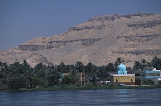 EGYPT, Nile Valley, Luxor, View across the River Nile towards a Mosque on the West Bank with a