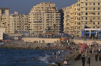 EGYPT, Nile Delta, Alexandria, "Corniche Waterfront seen in golden light. Busy beach with people