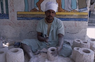 EGYPT, Nile West Bank , Luxor, Alabaster carver making items for tourists in Gurna village