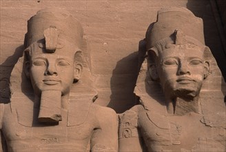 EGYPT, Nile Valley, Abu Simbel, Ramses II enthroned colossal statues. Detail of heads and upper