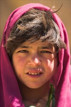 AFGHANISTAN, Bamiyan Province, Bamiyan , Girl that lives in a cave in the cliffs near empty niche