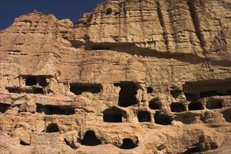 AFGHANISTAN, Bamiyan Province, Bamiyan , Caves in cliffs near empty niche where the famous carved