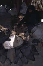 EGYPT, Eastern Desert, Bedouin woman cooking Chapatti