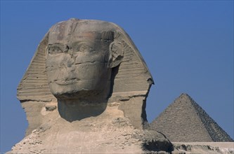 EGYPT, Cairo Area, Giza, The Sphinx with the Cheops Pyramid behind