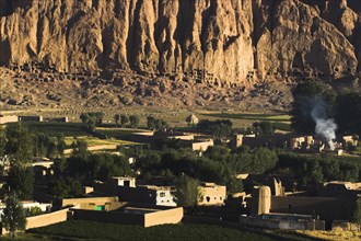 AFGHANISTAN, Bamiyan Province, Bamiyan, Village at base of cliffs near empty niche where the famous