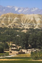 AFGHANISTAN, Bamiyan Province, Bamiyan, View over the village with mountains behind.