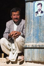AFGHANISTAN, between Yakawlang and Daulitiar, Syadara, Man sitting in doorway