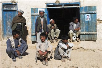 AFGHANISTAN, between Yakawlang and Daulitiar, Syadara, Group of men and young boys sat around a