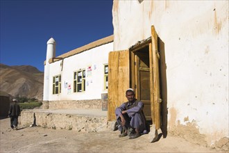AFGHANISTAN, between Yakawlang and Daulitiar, Syadara, Man sitting in doorway of mosqu