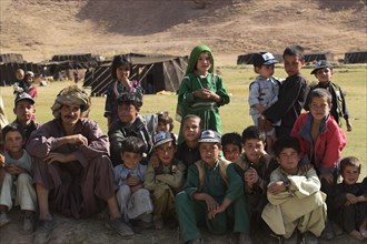 AFGHANISTAN, Ghor Province, Pal-Kotal-i-Guk, "Aimaq nomad camp, Aimaq man with children