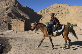 AFGHANISTAN, Ghor Province, Pal-Kotal-i-Guk, "Aimaq man riding horse