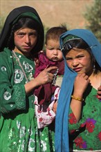 AFGHANISTAN, Ghor Province, Pal-Kotal-i-Guk, "Aimaq nomad camp, Aimaq girls and baby in front of