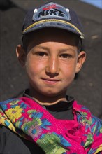 AFGHANISTAN, Ghor Province, Pal-Kotal-i-Guk, "Aimaq nomad camp, Aimaq boy wearing colourful scarf