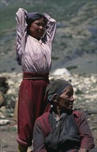 NEPAL, Mustang, Nomads, "Tibetan nomads.  Elderly seated woman with young girl standing behind with