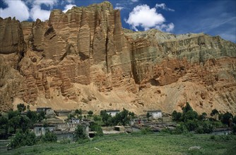 NEPAL, Mustang, Drakhmar, "Summer landscape.  Adobe village housing and cultivated land at foot of