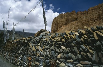 NEPAL, Mustang, Drakhmar, Prayer wall made from stacked stones engraved with prayers and with