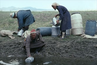 MONGOLIA, Agriculture, Mongolian herdsmen and woman fetching water.
