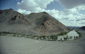 MONGOLIA, Hovd River, Bend in river through barren landscape with trees along the river the only