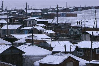 MONGOLIA, Ulan Bator, Snow covered rooftops of traditional housing in city suburb in winter.