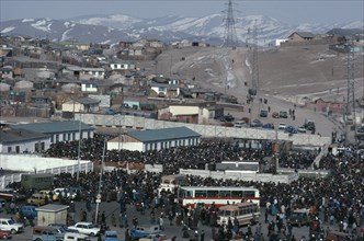 MONGOLIA, Ulan Bator, View over crowded Sunday market with houses stretched across hillside above