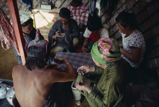 MONGOLIA, People, Playing game of dominoes inside yurt.