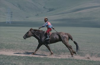 MONGOLIA, Animals, Child jockey  competing in National Day horse race.
