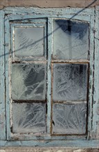 MONGOLIA, Architecture, Detail of window with pale blue painted frame and frost patterns decorating