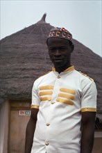 NIGERIA, People, Three-quarter portrait of young man working for hotel.