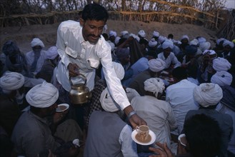 INDIA, Rajasthan, Bhikodai, Chai being served at a Moslem wedding in village in the Thar Desert.