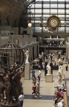 FRANCE, Ile de France, Paris, "Musee d’Orsay interior, visitors walking amongst sculpture inside