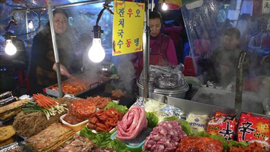 KOREA, South, Seoul, "Namdaemun - Namdaemun market, December evening, food stall, women cooking,
