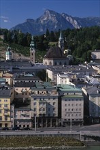 AUSTRIA, Salzburg, City view with Untersburg Mountain behind.  Church spire and towers and