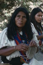 COLOMBIA, Sierra Nevada de Santa Marta, Ika, Ika widow Adelaida sewing traditional mochila shoulder