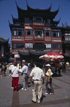 CHINA, Shanghai, "Yu Gardens street scene with shoppers, tourists, shops and souvenir stalls."
