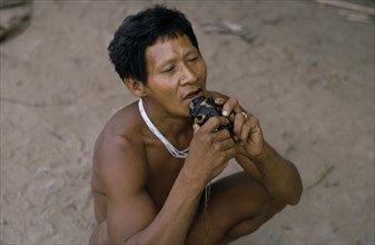 COLOMBIA, North West Amazon, Tukano Indigenous People, Barasana shaman playing deer skull flute