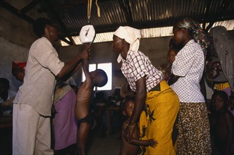 KENYA, Kibwezi, Children being weighed in mobile clinic.