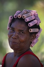 DOMINICAN REPUBLIC, Rodriguez, Head and shoulders portrait of Creole woman with her hair in pink