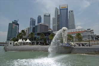 SINGAPORE, Financial District, Merlion and the city skyline viewed from the water.