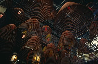 HONG KONG, Central District, Man Mo Temple, Spiral cones of incense hanging from roof of the Man Mo